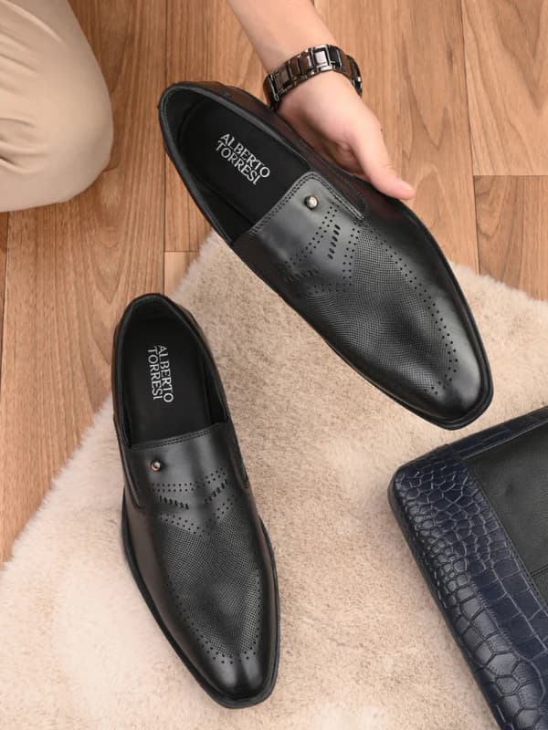 A collection of men's leather dress shoes and boots